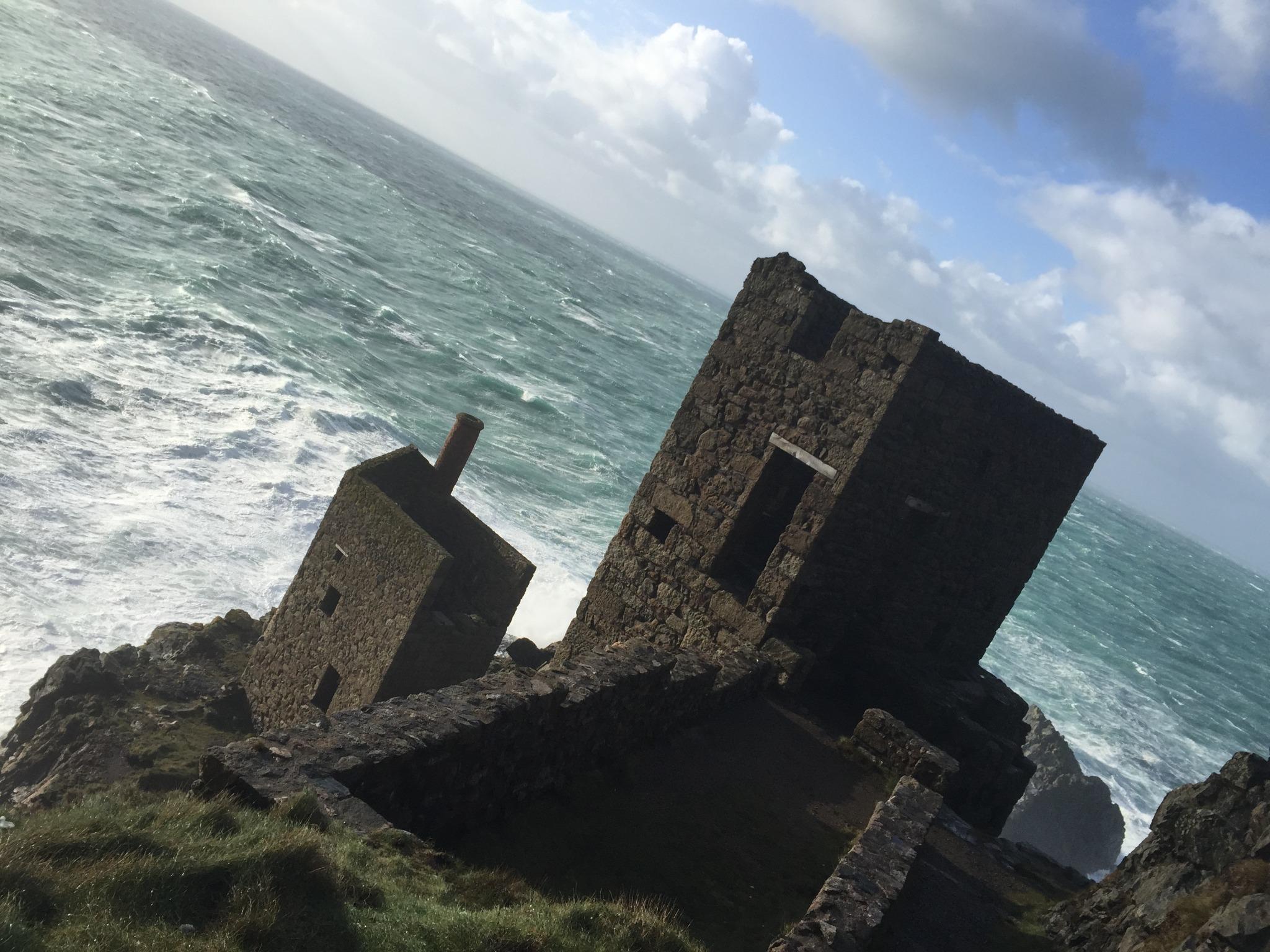Ruined Cornish tin mine buildings above the Atlantic surf